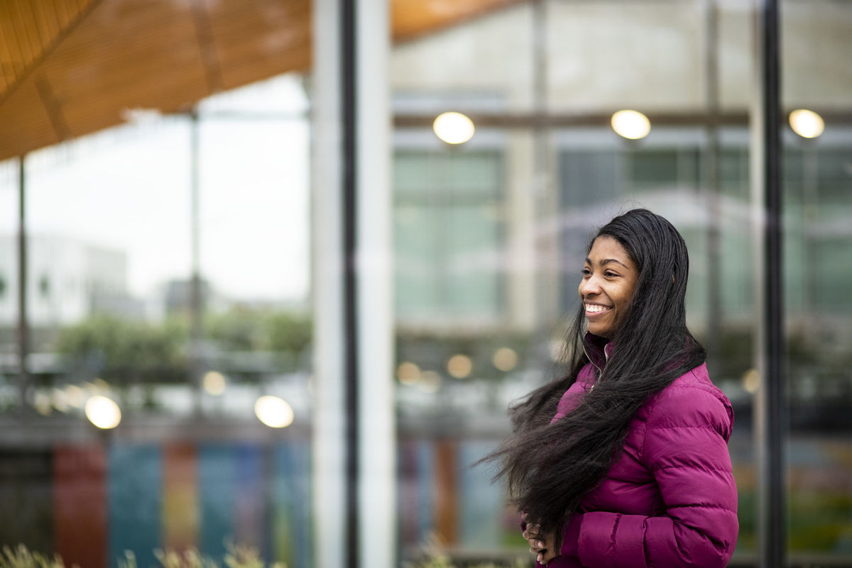 Dayja Burton standing against a window