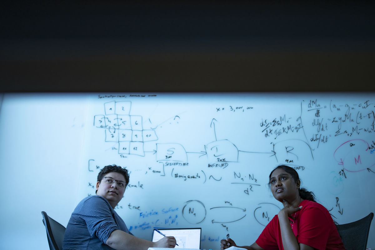 Image of two researchers from Boni's lab.