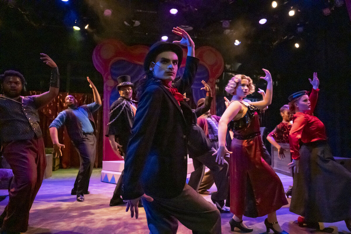 Image of the cast of Mystic Rapture performing on stage and in costume.