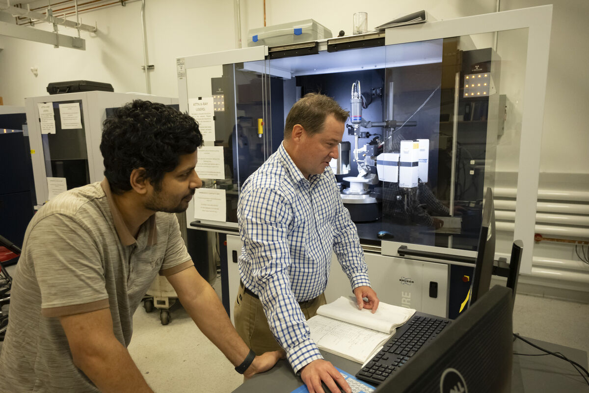 Image of Michael Zdilla working alongside a student.