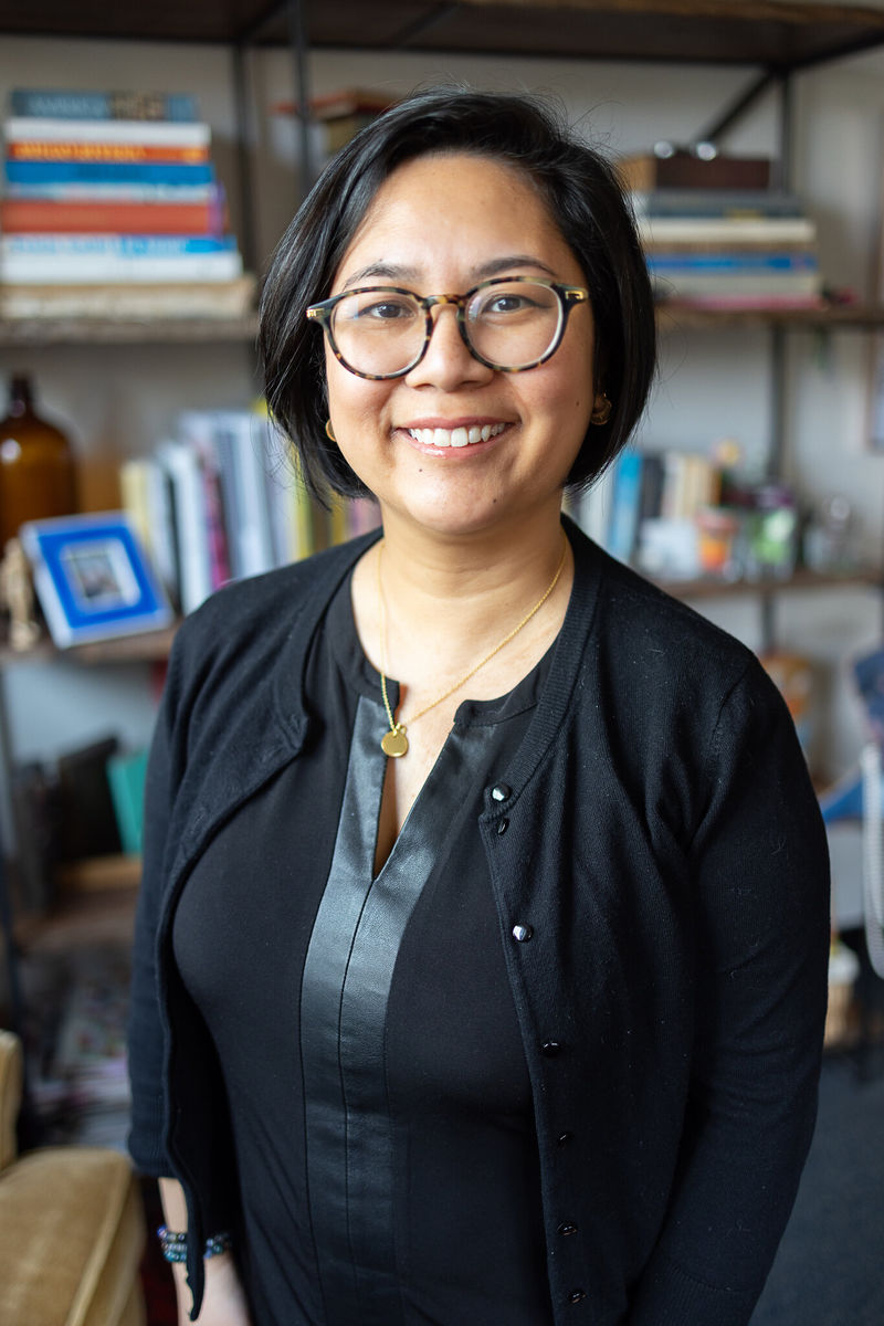 Jackie Lopez standing in front of books