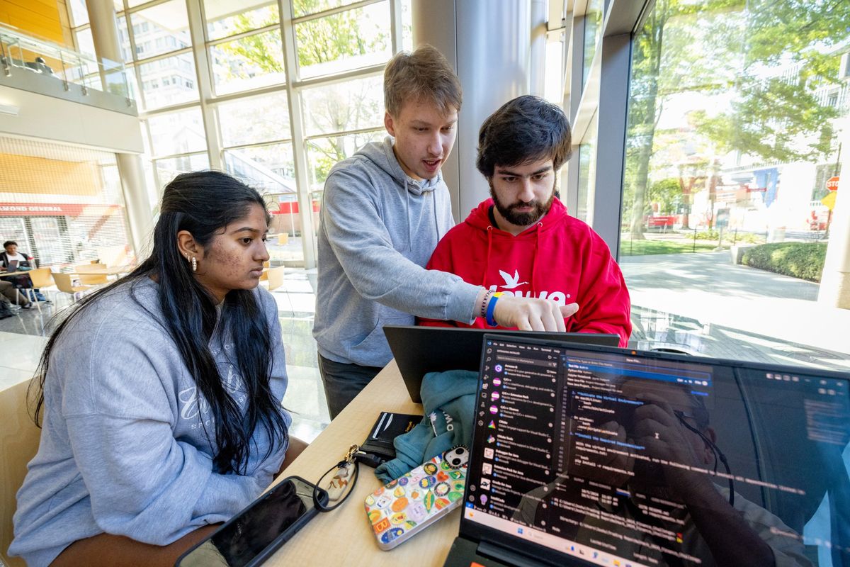 Image of a group of students working at OwlHacks.