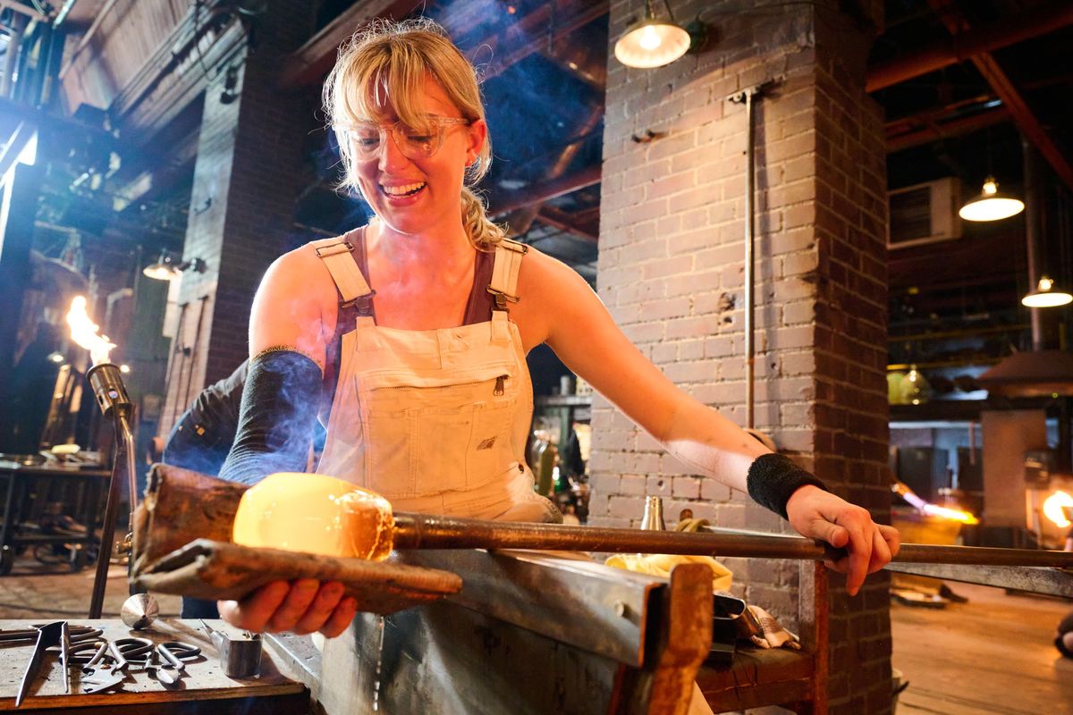 Image of Gemma Hollister working with hot glass on the set of Blown Away.