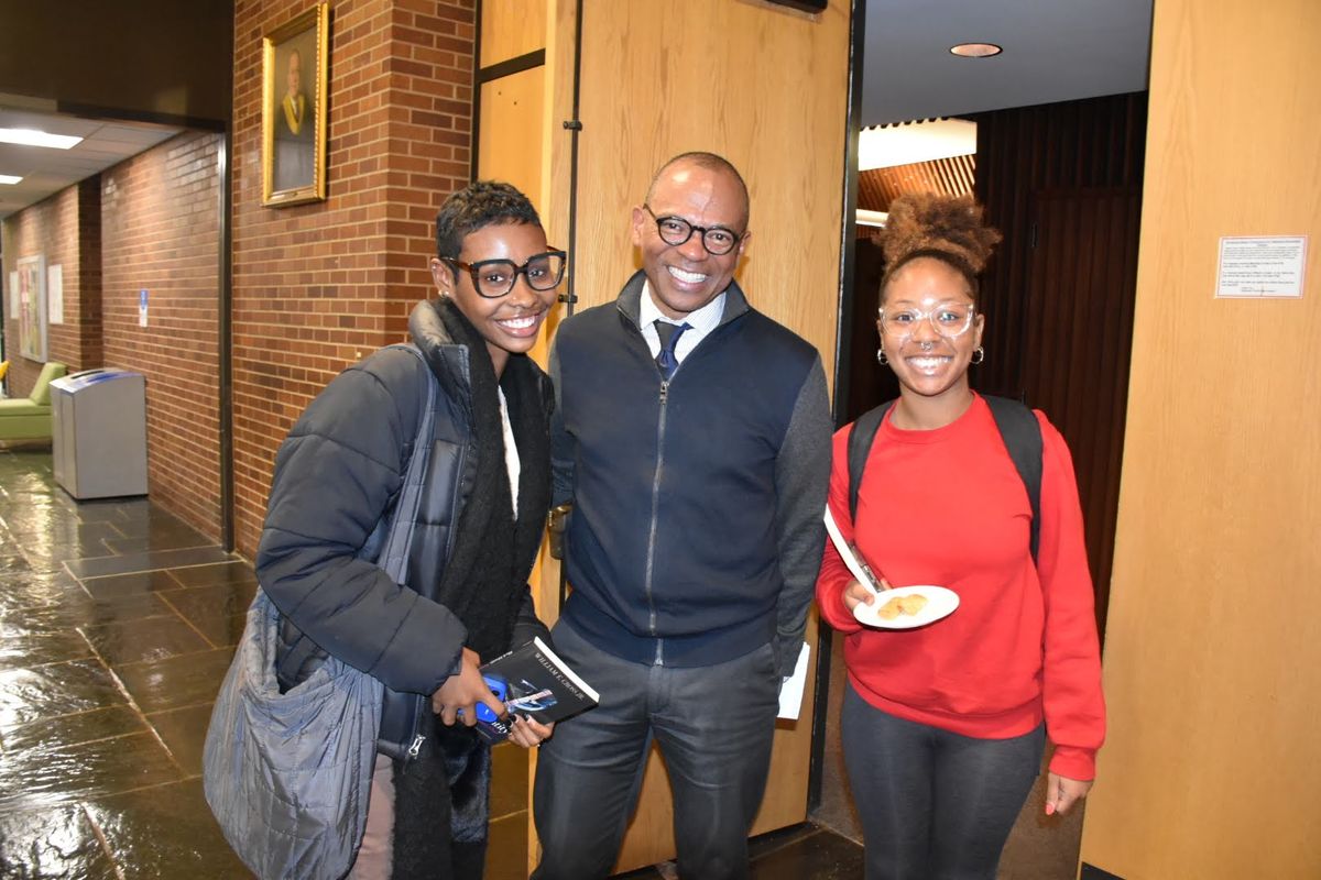 Dean Davis with two students