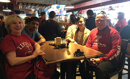 The Smiths, Deng and Shah sitting together at a table at the Draught Horse. 