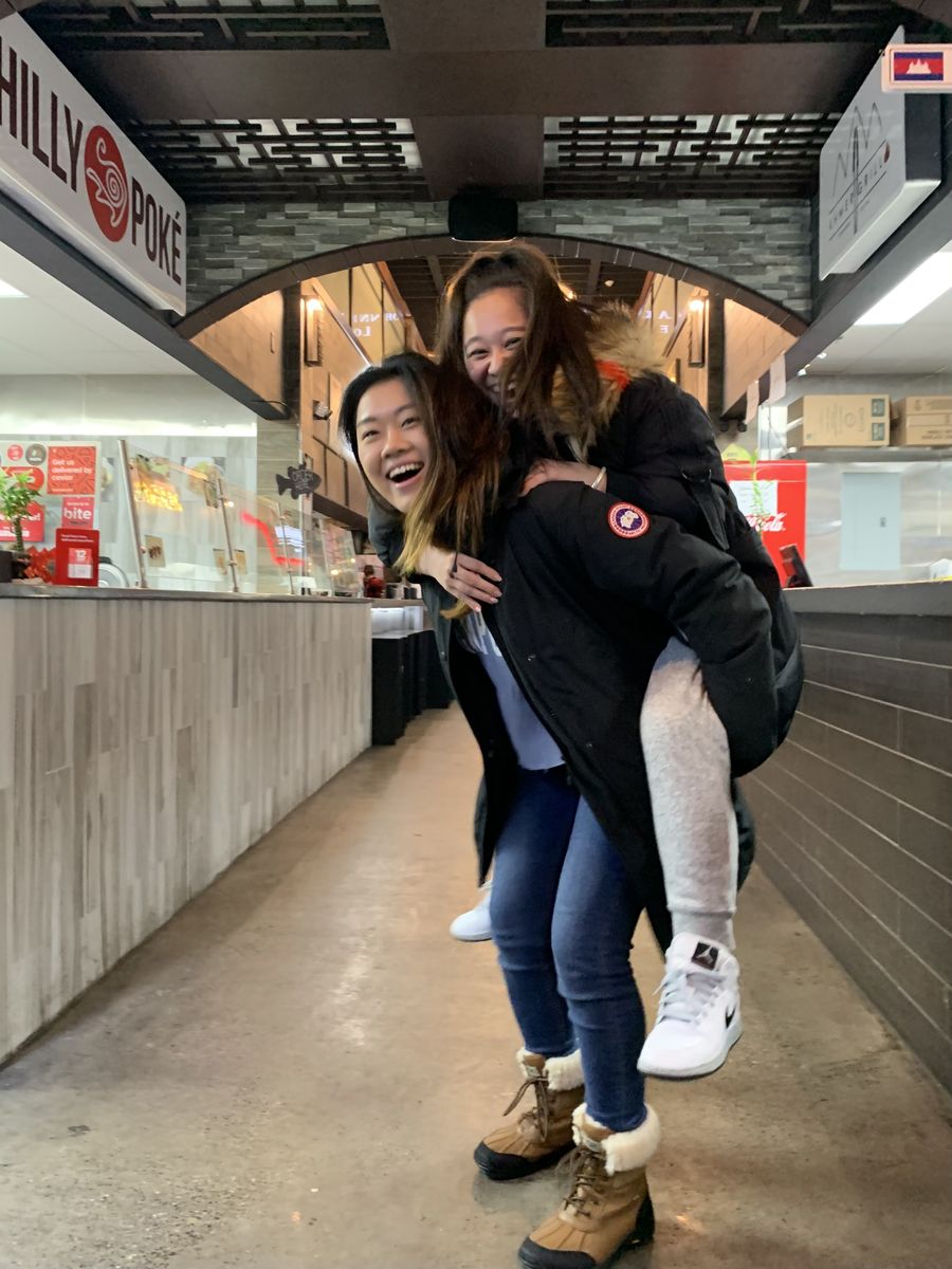 Image of Jenny Back and a friend in front of a restaurant in Chinatown