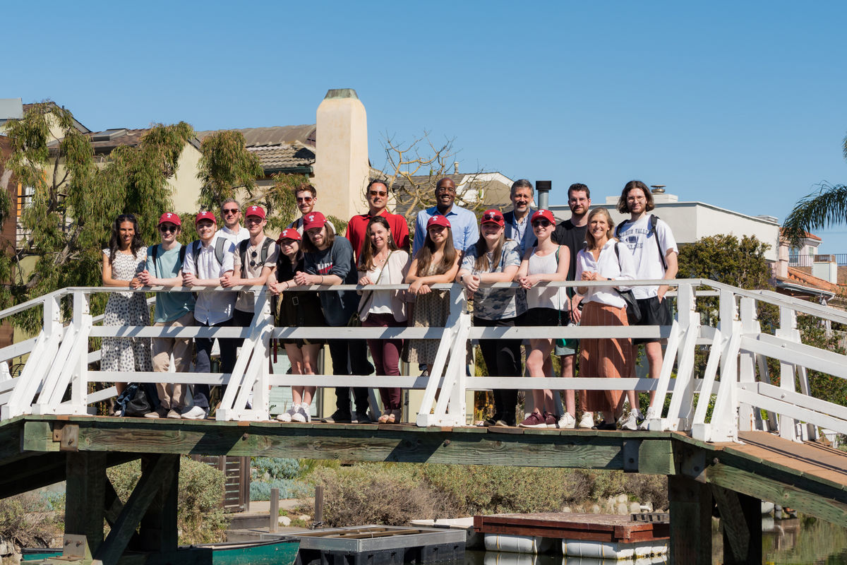 Image of President Wingard and students on a bridge.