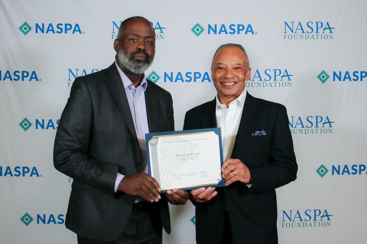 Olan Garrett and Michael Jackson holding the NASPA award