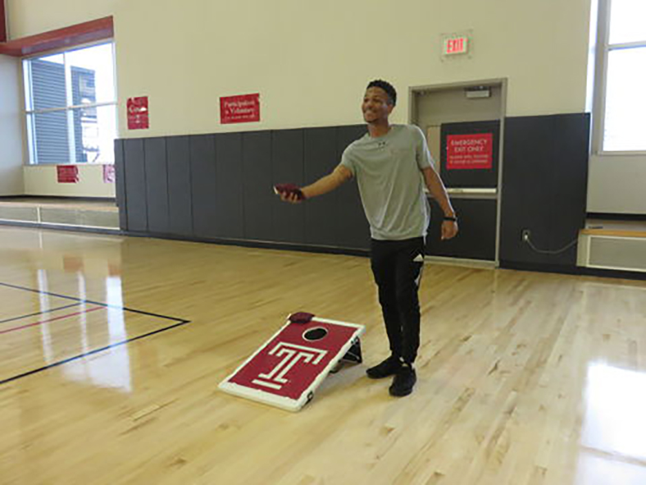 Student playing cornhole
