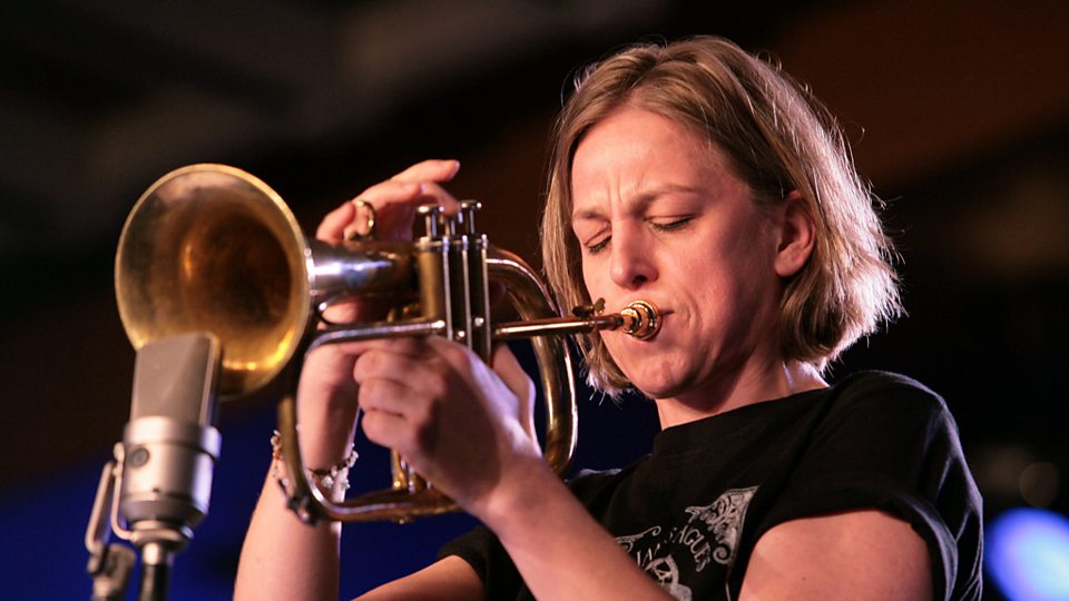 photograph of woman playing trumpet
