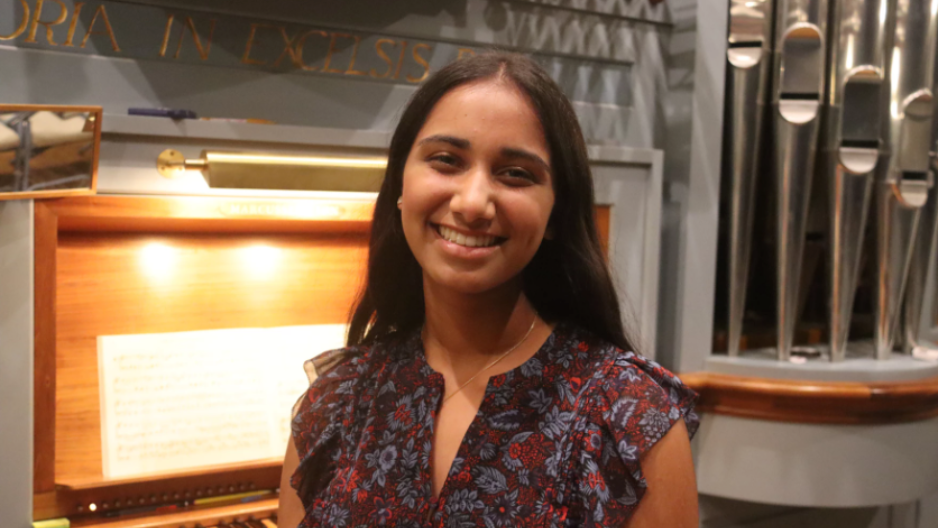 Photo of young girl in front of an organ