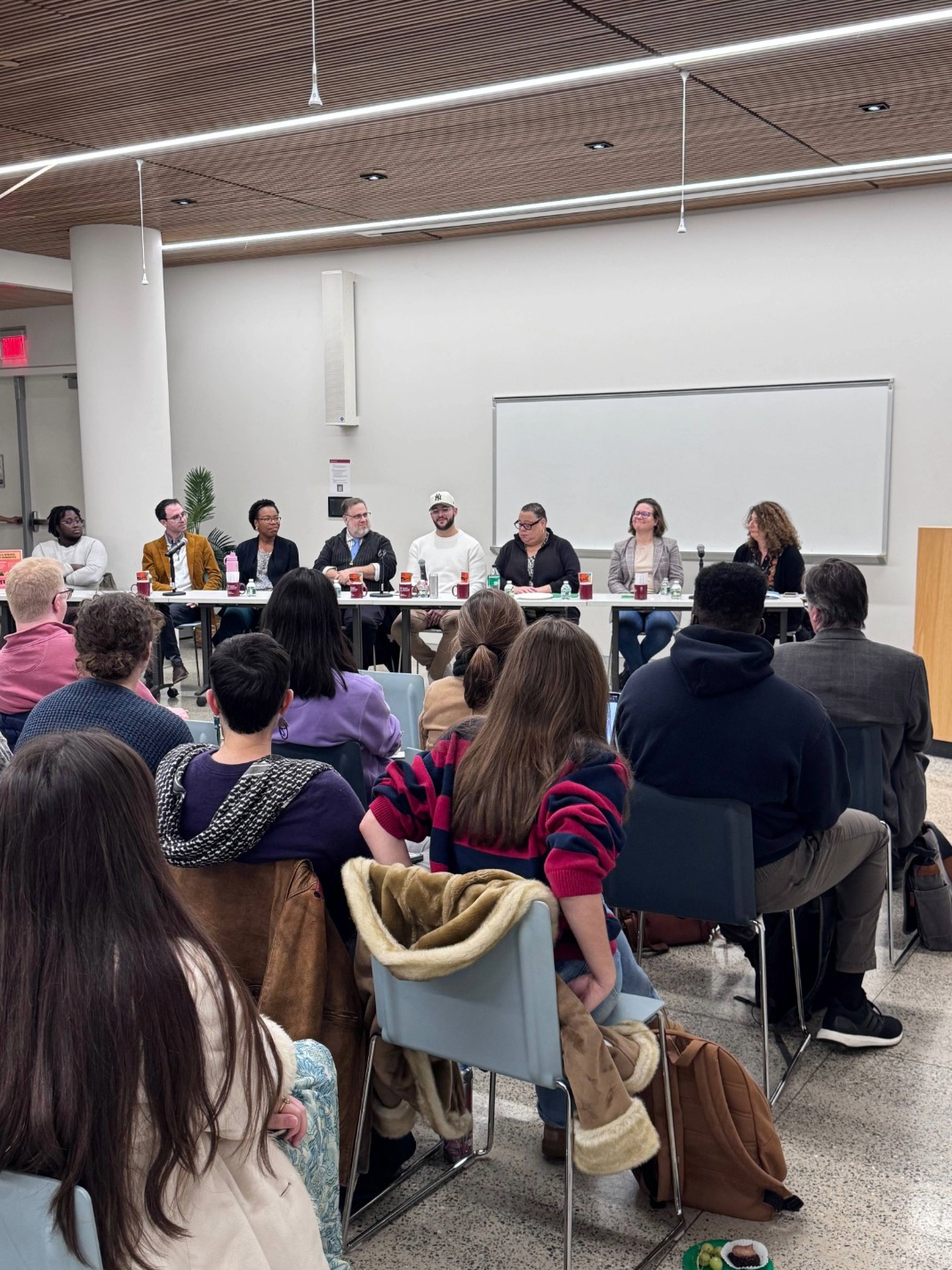 Photo of event panelists and crowd.