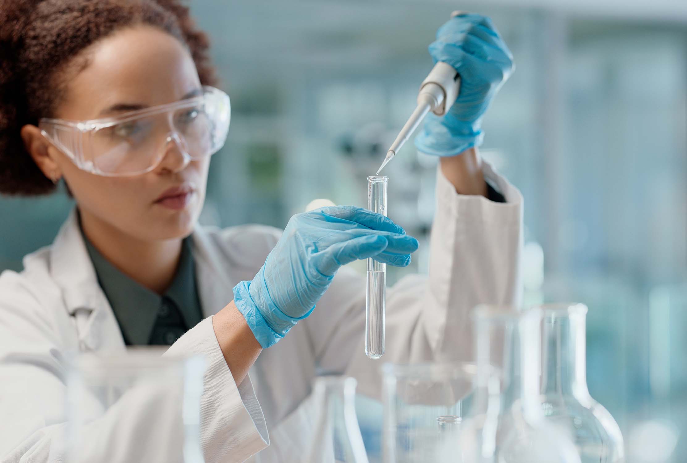 Scientist in lab with beakers