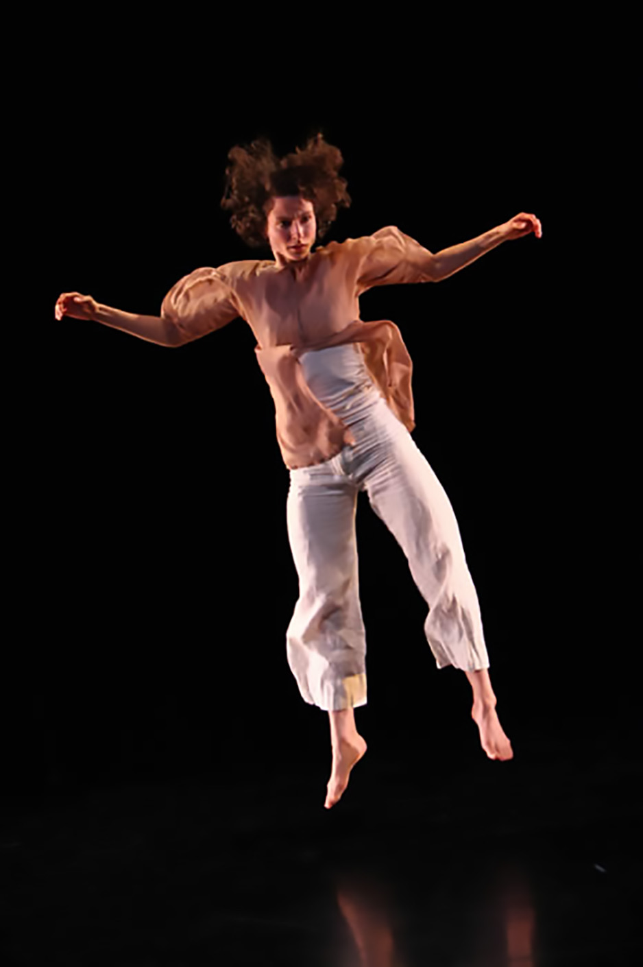 Black background with dancer leaping
