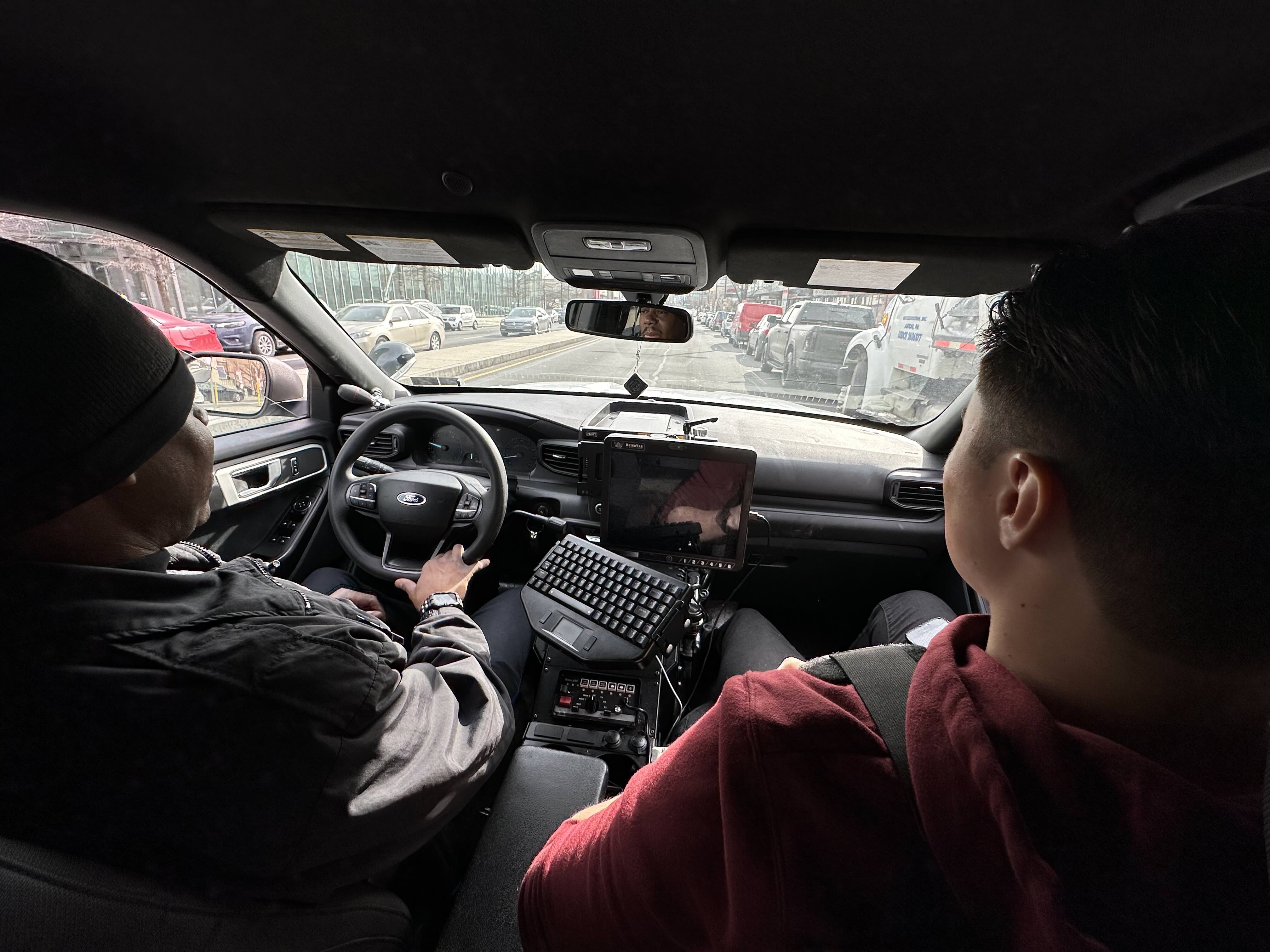 Temple University junior psychology major Lucas Burke (right) rides along in a patrol car with Temple Police Sergeant Elijah Lewis.