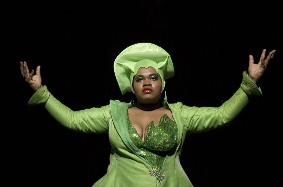 Black Woman in a shiny green dress and hat