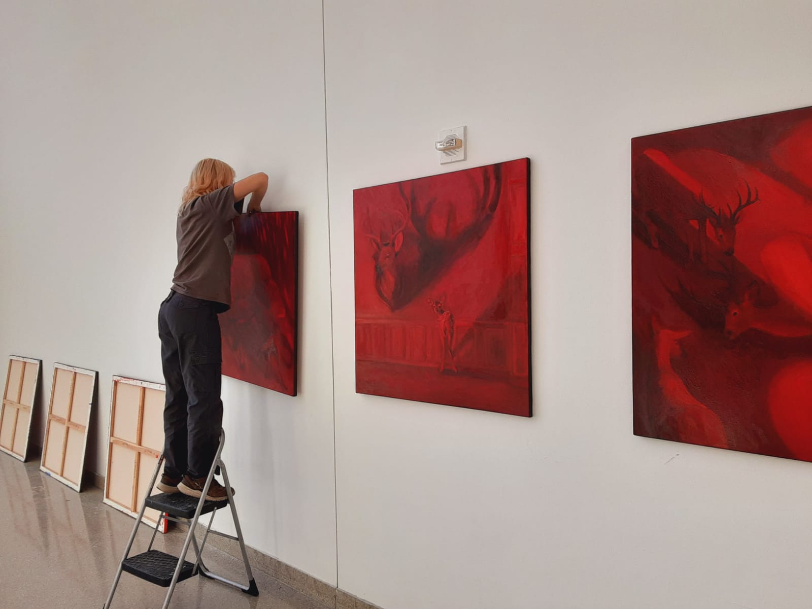 CARAS grant recipient Sofia Angelini hangs pieces from her show "Wrong Place, Wrong Time".