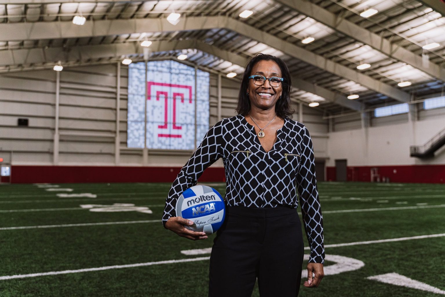 Associate Professor Debra Blair holding a ball on a Temple field