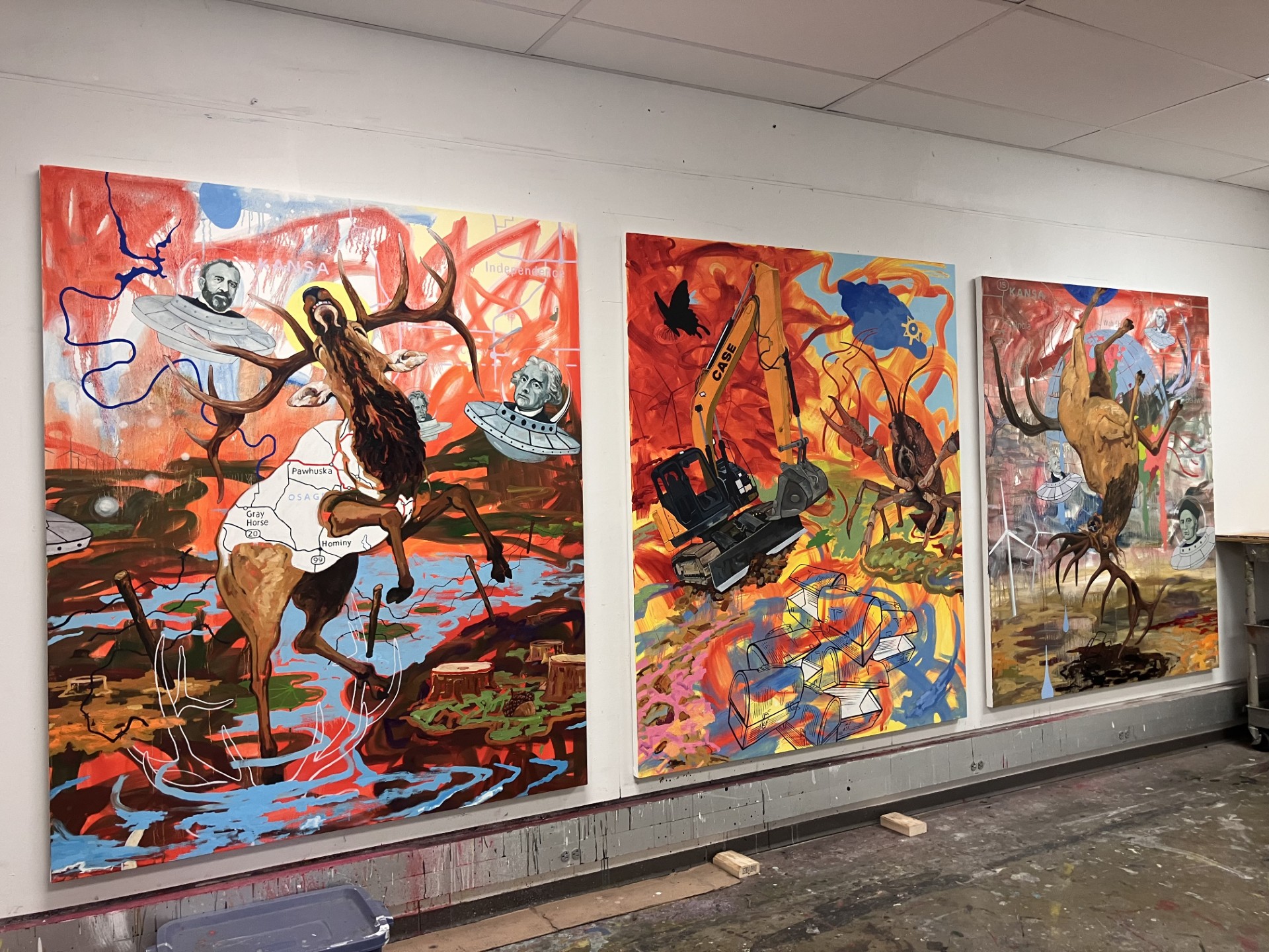 Three paintings by Norman Akers, the inaugural Edgar Heap of Birds Family resident, hang side by side in the Tyler studio