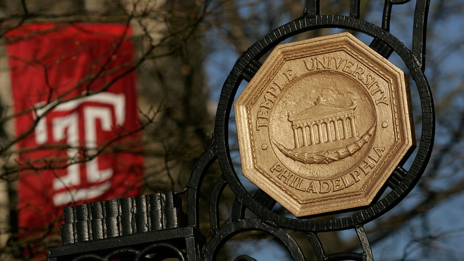 the iron gate leading onto Temple's Main Campus and a red Temple "T" flag.