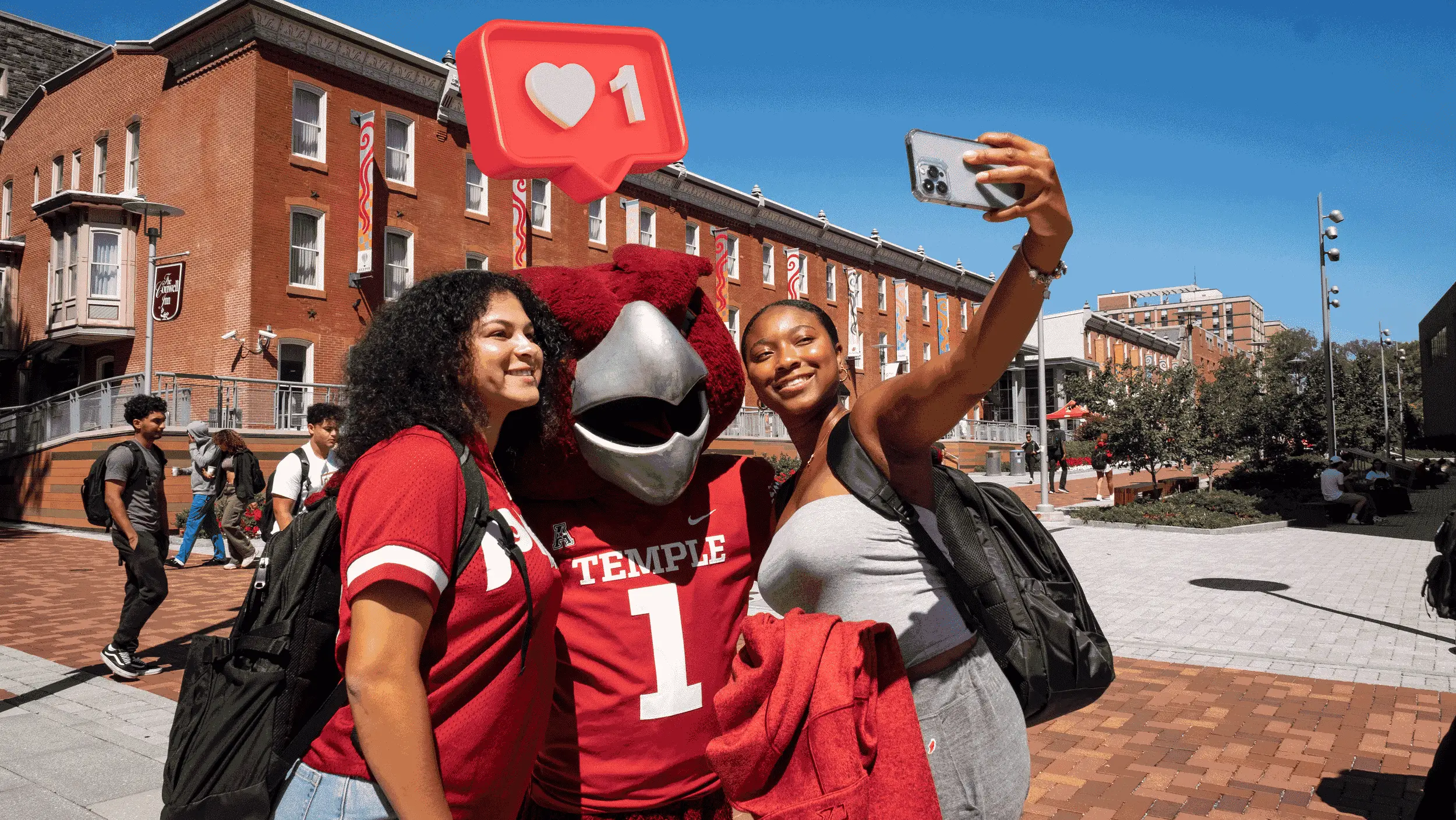 Students posing for a selfie with Hooter