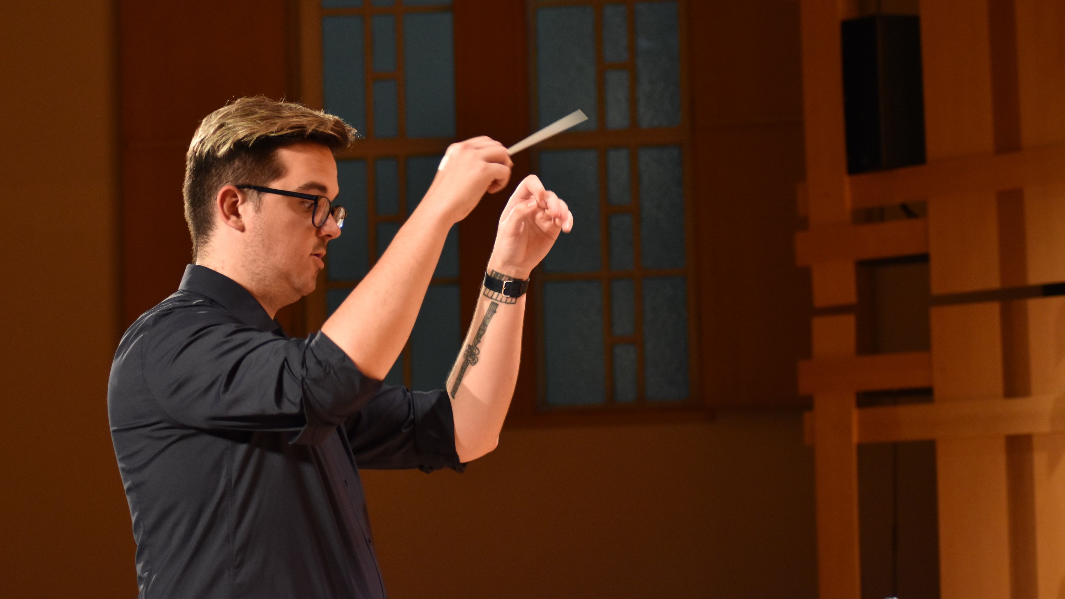 Image of Baker Purdon conducting a choir.