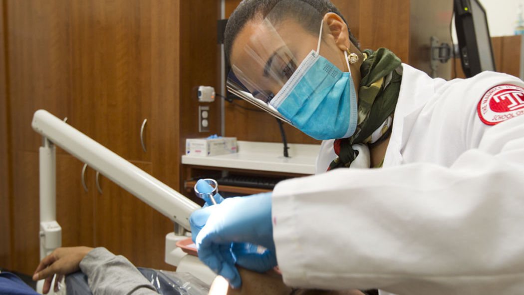 Temple Dentist work in clinic with blue gloves