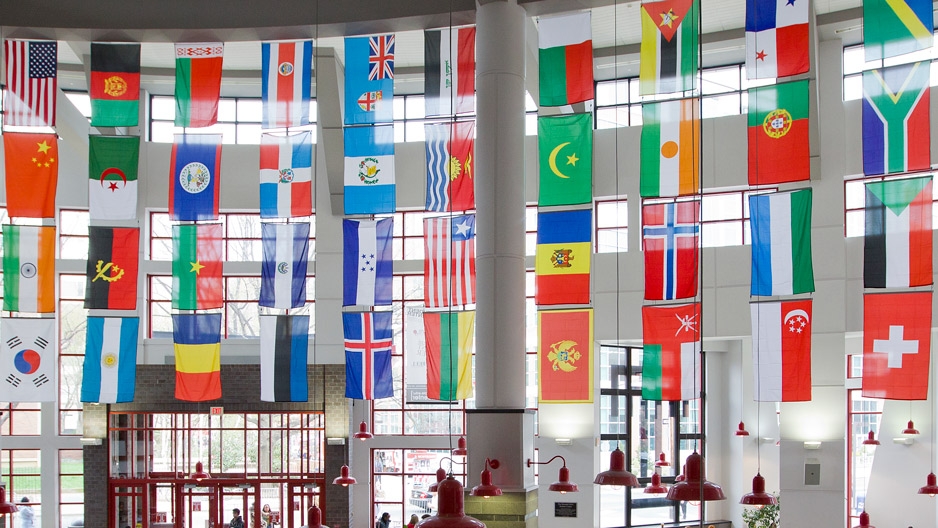 flags of countries around the world hanging in an atrium.