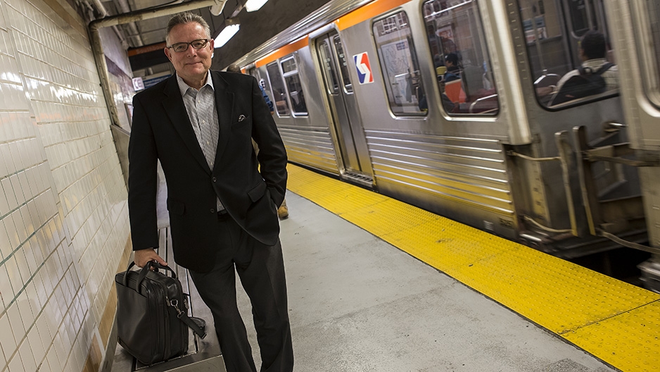 David Boardman standing next to a SEPTA subway train. 