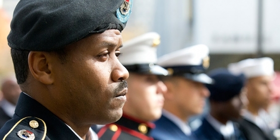 Uniformed service members attending a Temple Veterans Day ceremony.