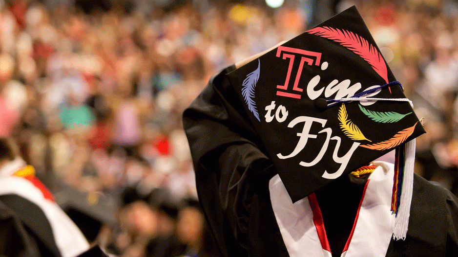 A graduation cap that reads "time to fly"