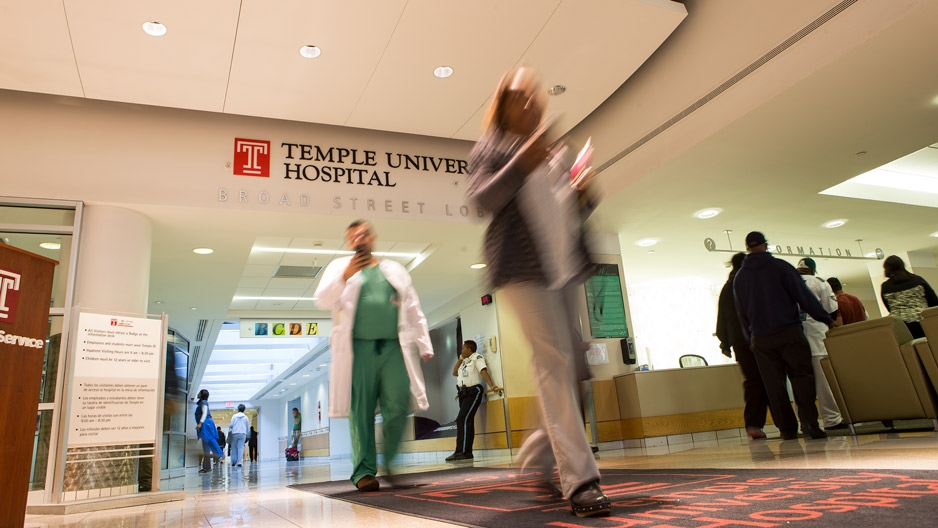 People walking through the entrance to Temple University Hospital.