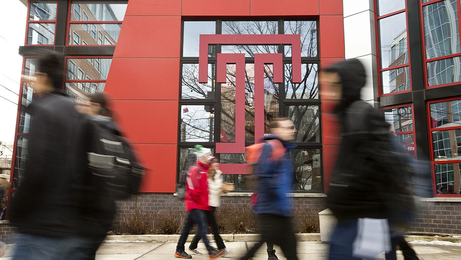Students walking in front of a Temple “T”.