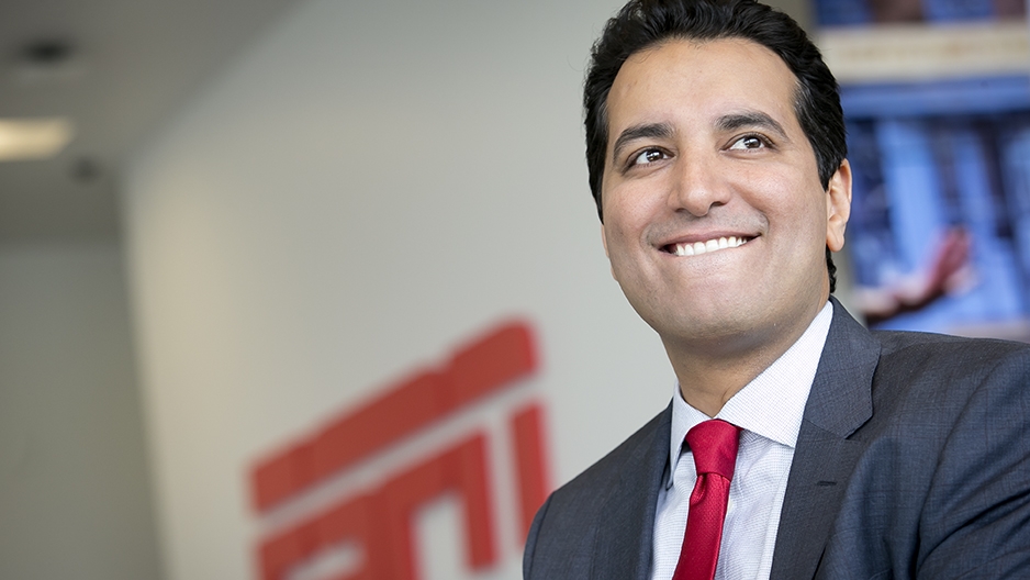 Kevin Negandhi smiling with an ESPN logo in the background.