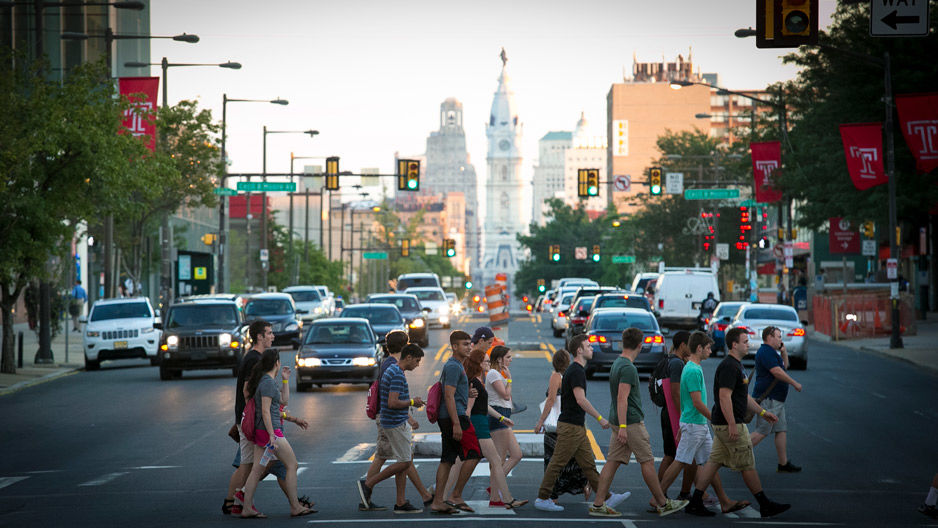 A group of student's crossing Broad Street on campus. 