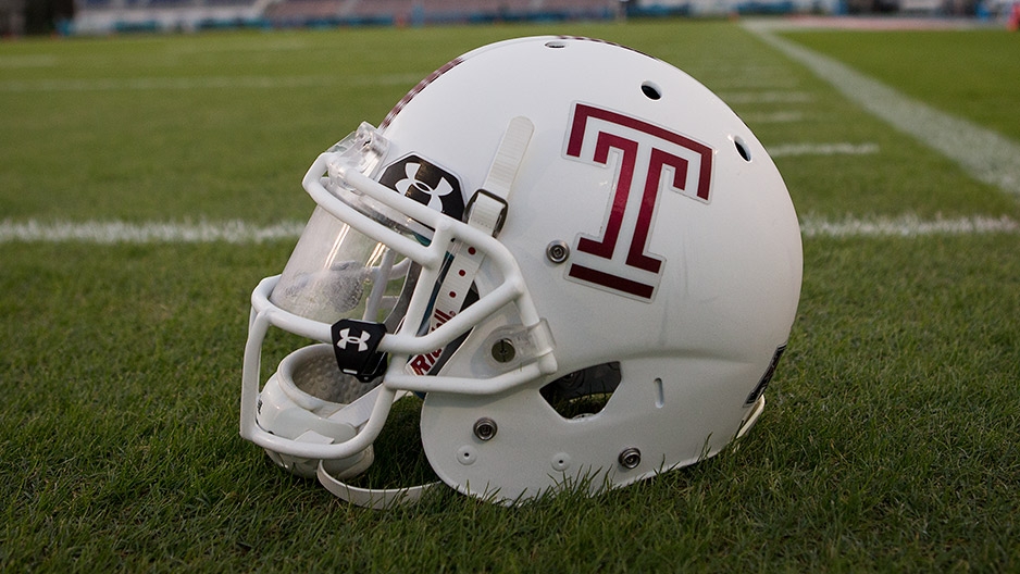 A white Temple football helmet with a cherry Temple "T"