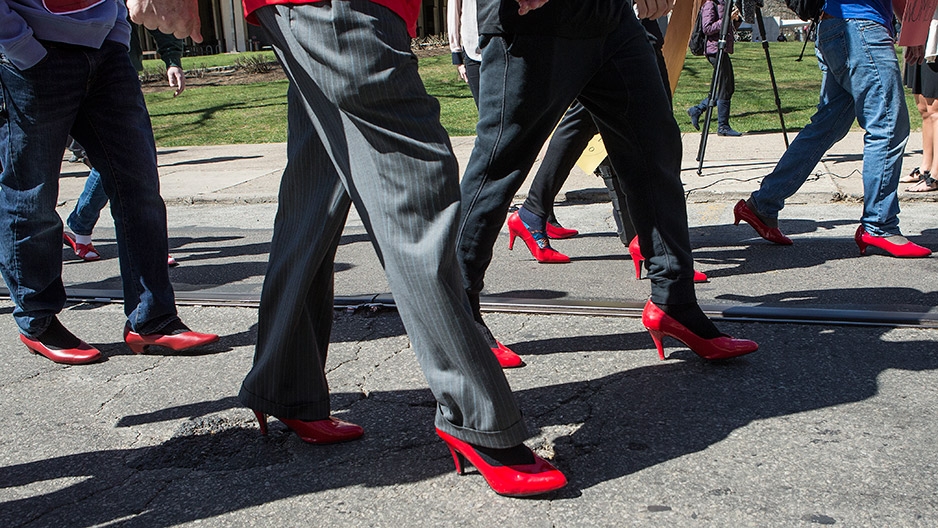 Men walking around Main Campus in red high heels.