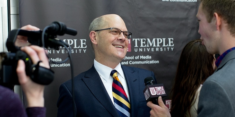 Steve Charles smiling while being interviewed on-camera by Temple Update.