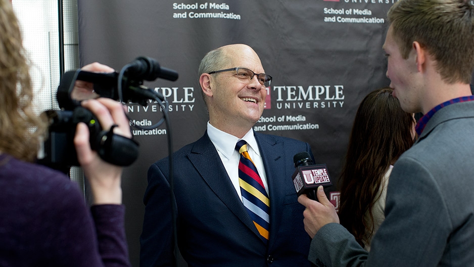 Steve Charles smiling while being interviewed on camera by Temple Update.