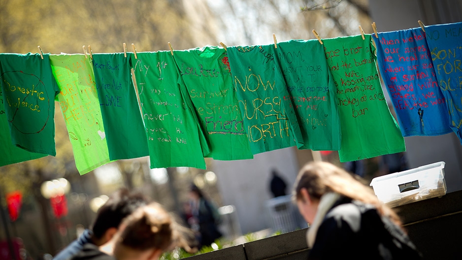 Green t-shirts with messages hanging from a clothesline in Founder’s Garden.