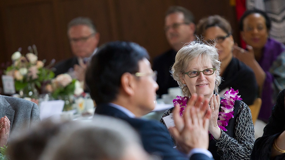 A female faculty member applauding during Temple’s Faculty Awards Luncheon.