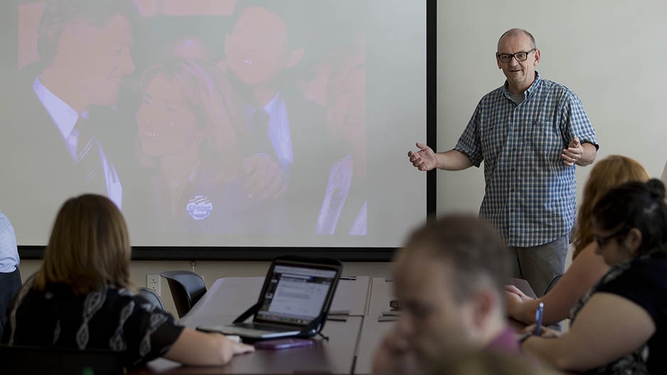 Jim Macmillan talking to students in a classroom. 