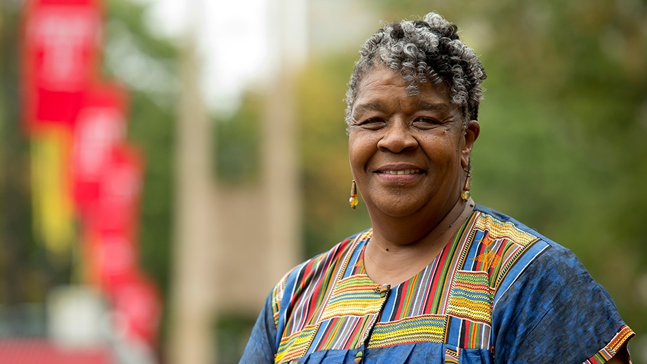 Ulicia Lawrence standing on Main Campus smiling.  