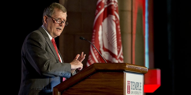 Acting President Richard Englert talking at a podium. 