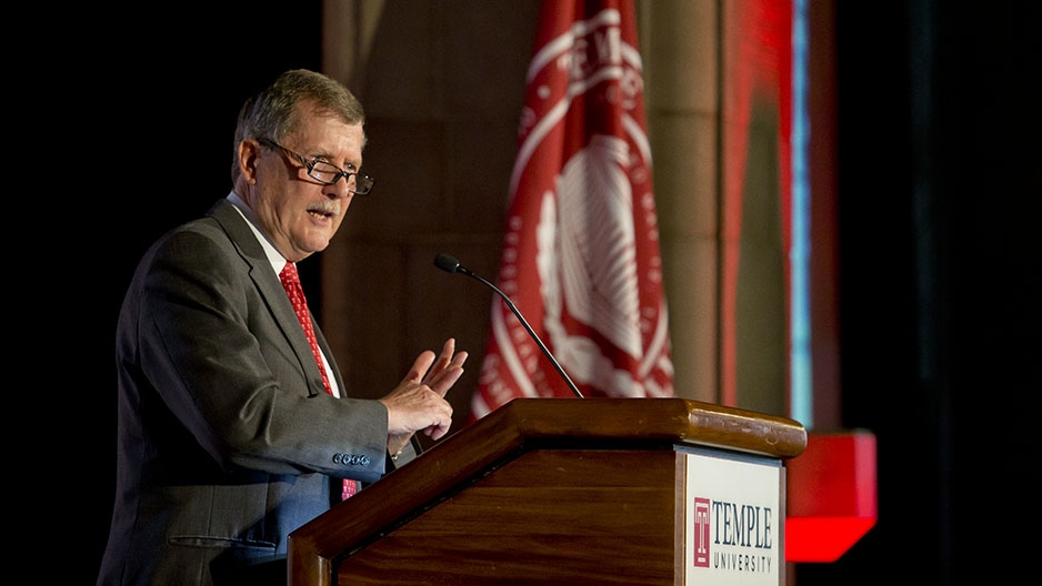 Acting President Richard Englert talking at a podium.