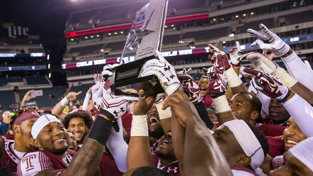 Temple’s football team holding the AAC East Conference Division title trophy.