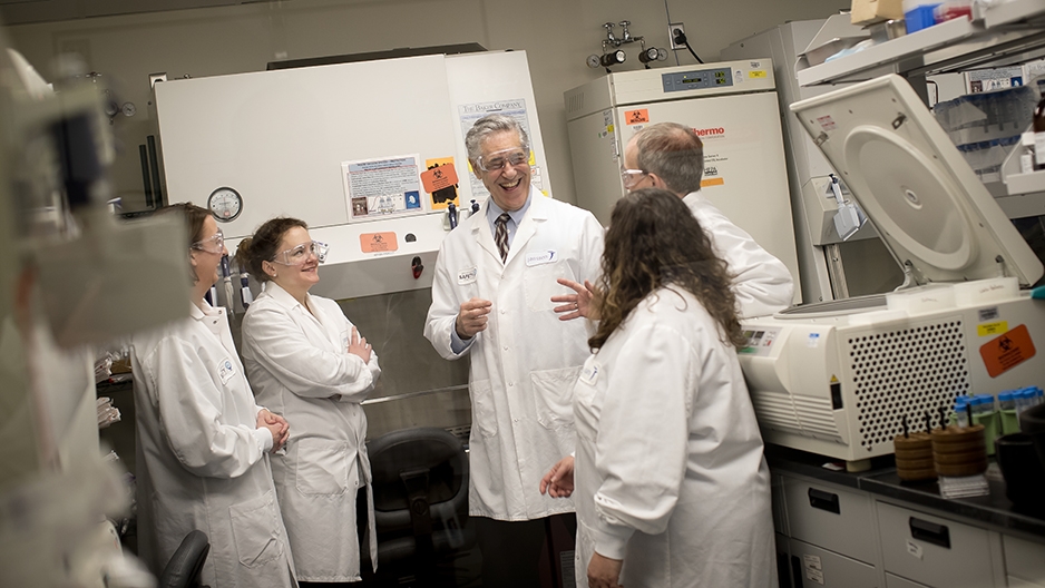 A team of scientists talking in a laboratory.