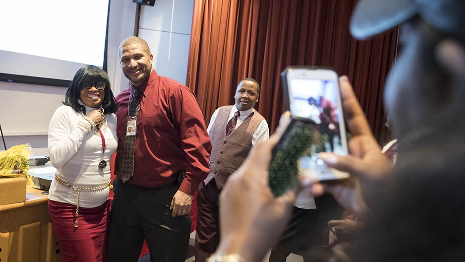  A student and an administrator getting their picture taken with a cell phone. 