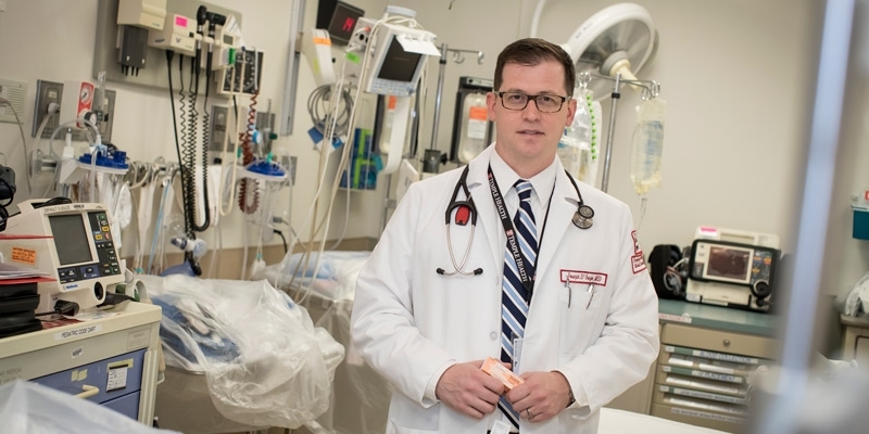 Dr. Joseph D’Orazio holding naloxone in a trauma bay at Temple Hospital.