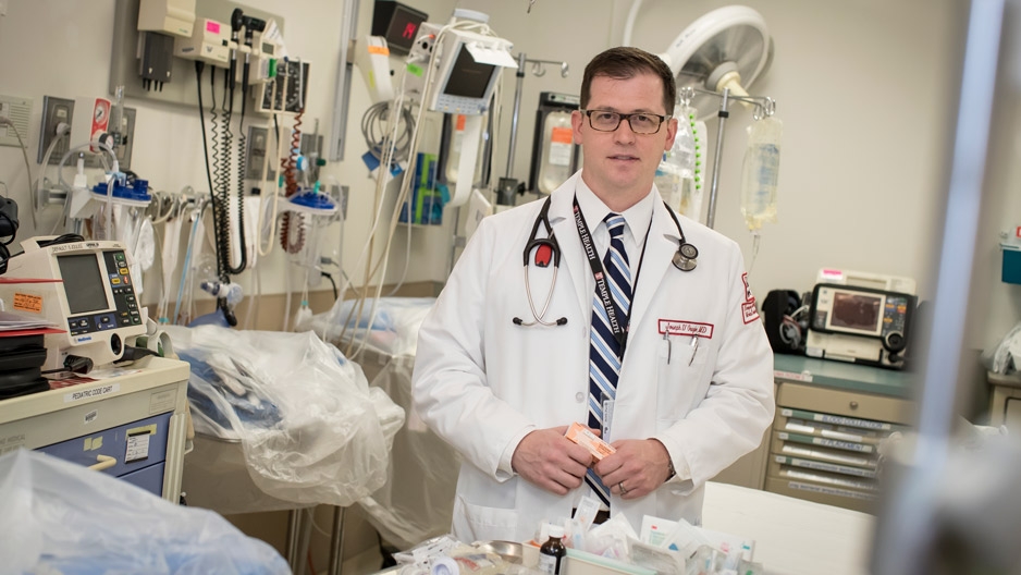Dr. Joseph D’Orazio holding naloxone in a trauma bay at Temple Hospital.